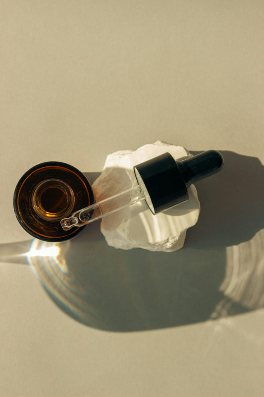 Simple background amber dropper bottle ariel view 